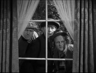 Three Stooges looking in a window