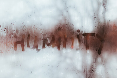 Steamy window with the word humidity written on it.
